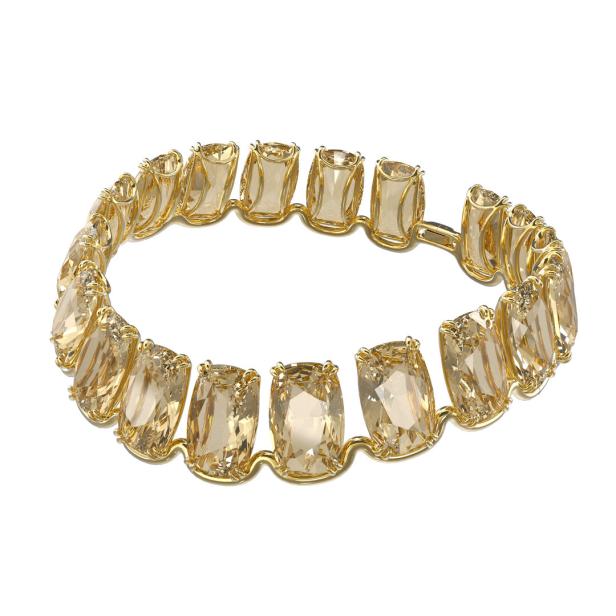 Ein goldenes Armband mit großen, rechteckigen, bernsteinfarbenen Steinen.