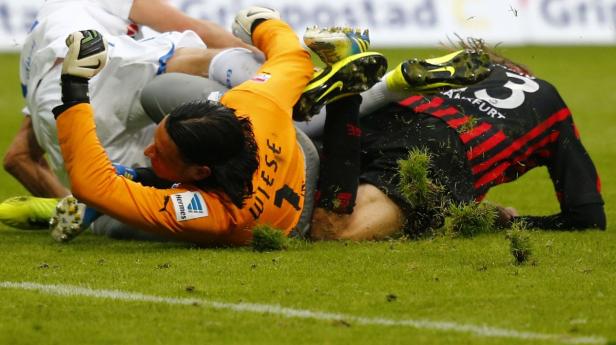 Mehrere Fußballspieler liegen während eines Spiels auf dem Rasen.
