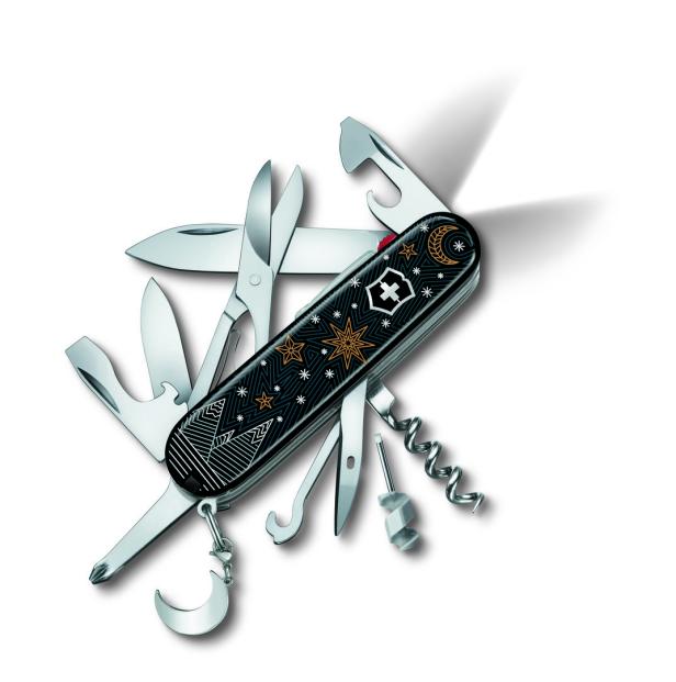 Ein Schweizer Taschenmesser mit Sternen- und Monddesign auf schwarzem Hintergrund.