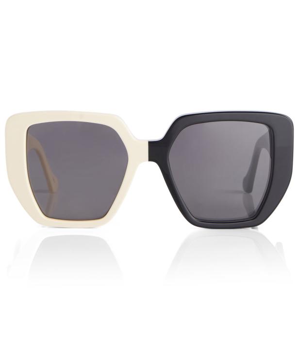 Eine Sonnenbrille mit einem Rahmen, der halb schwarz und halb cremefarben ist.