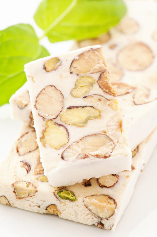 Torrone slices with decoration asw closeup on a white plate