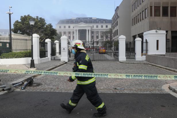 Firefighters work after a fire broke out in the Parliament in Cape Town