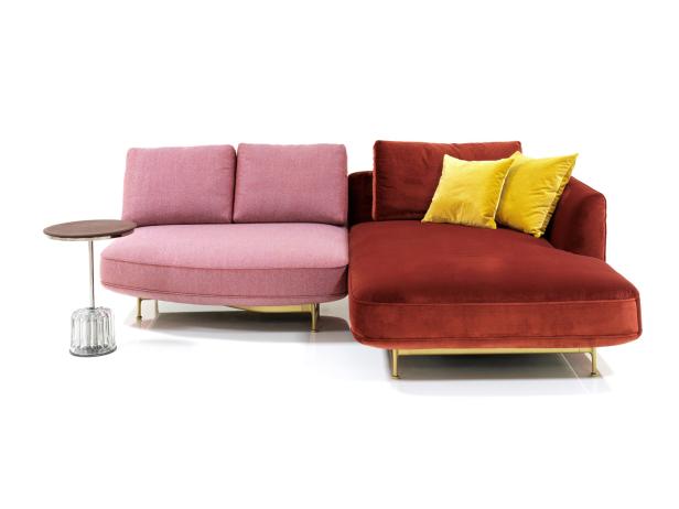 Ein rosafarbenes und ein rotes Sofa mit goldenen Beinen und gelben Kissen stehen auf einem weißen Hintergrund.