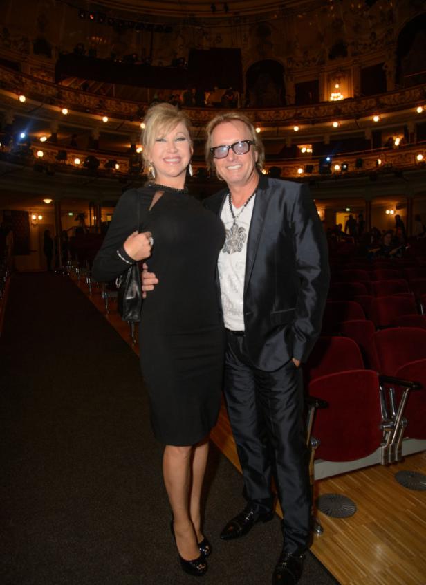 Die Geissens Eine Frau in einem schwarzen Kleid und ein Mann mit Sonnenbrille posieren in einem Theater.