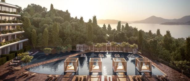 Ein Luxusresort mit Pool, Cabanas und Blick auf das Meer und bewaldete Hügel.
