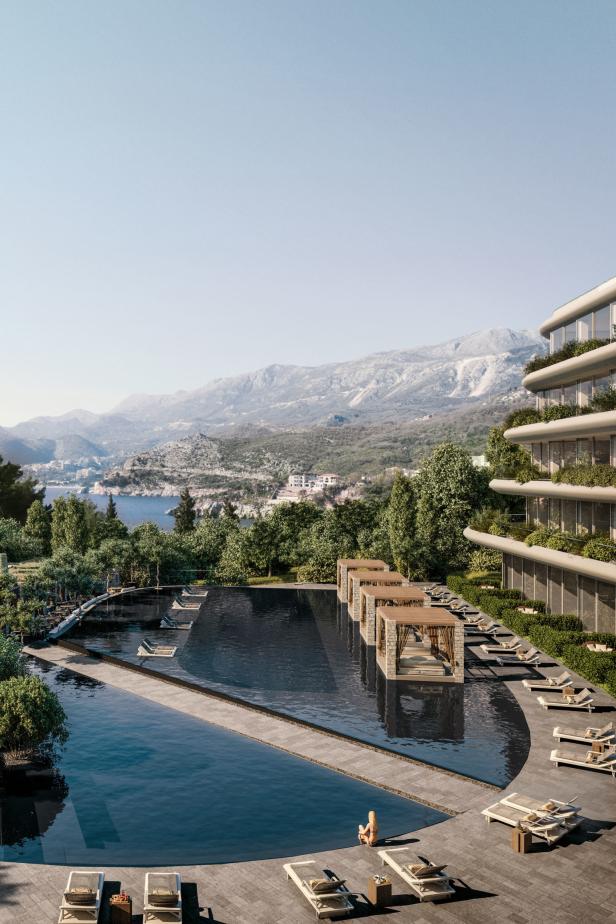 Ein Luxusresort mit einem Infinity-Pool und Blick auf die Berge und das Meer.