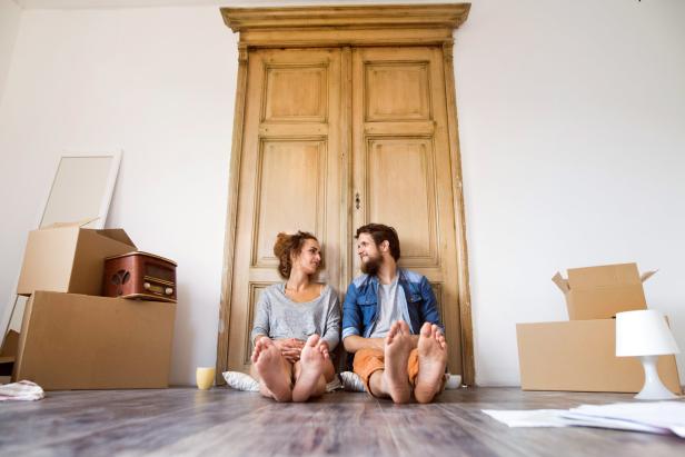 Young couple moving in new house, resting.