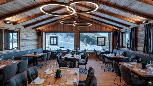 Ein Restaurant im Chalet-Stil mit Blick auf eine verschneite Landschaft.