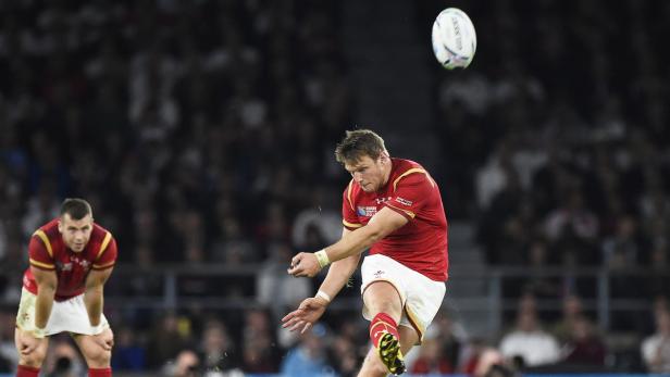 Ein walisischer Rugbyspieler schießt den Ball während eines Spiels.