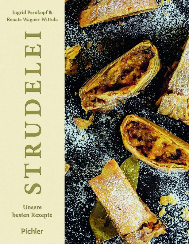 Ein aufgeschnittener Strudel, bestäubt mit Puderzucker, liegt auf einem dunklen Untergrund.