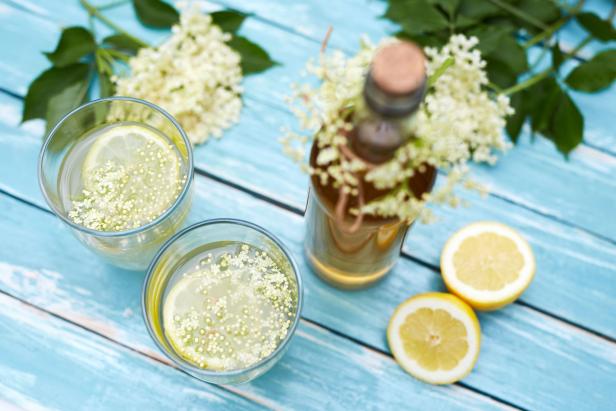 Two glasses of elderflower lemonade and bottle