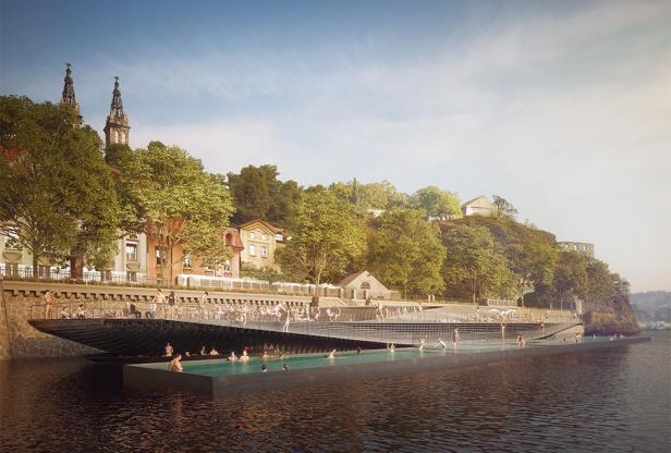 Ein Badeschiff mit vielen Menschen schwimmt auf einem Fluss in Prag.