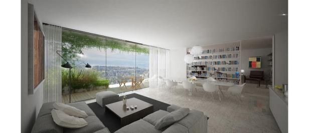 Ein modernes Wohnzimmer mit Bücherregal und Blick auf eine Stadt.