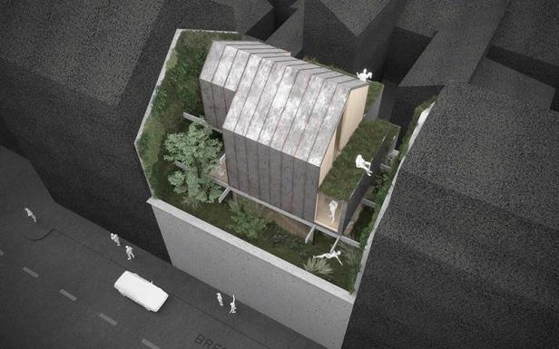 Ein Modell zeigt ein modernes Stadthaus mit begrüntem Dach und vertikalen Gärten.