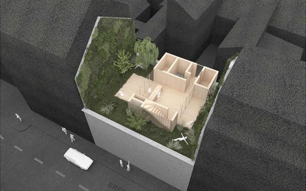 Ein Modell zeigt ein modernes Stadthaus mit begrüntem Dachgarten.