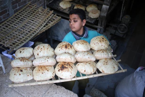 Egyptians buy bread in Cairo
