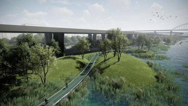 Eine grüne Fußgängerbrücke führt durch eine Flusslandschaft unter mehreren Autobahnbrücken hindurch.