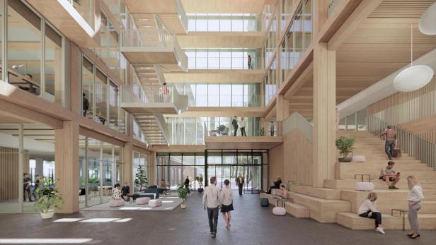 Die Lobby des iCampus im Werksviertel mit Personen auf Treppen und in Aufenthaltsbereichen.