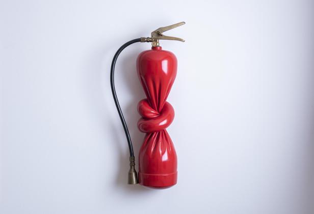 Ein roter Feuerlöscher ist in der Mitte wie ein Ballon verknotet.
