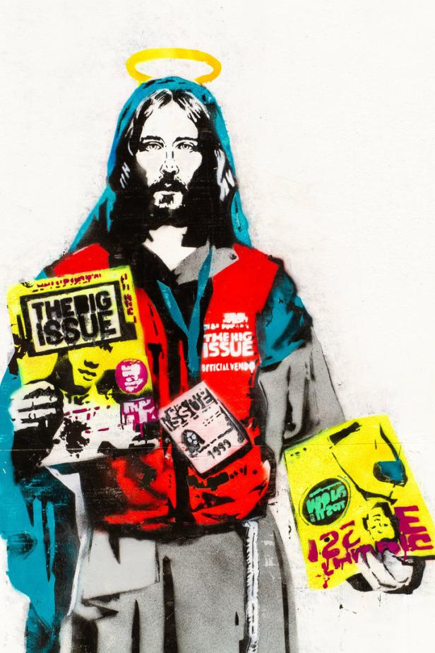 Ein Graffiti zeigt eine stilisierte Jesusfigur mit Heiligenschein, die „The Big Issue“-Magazine verkauft.