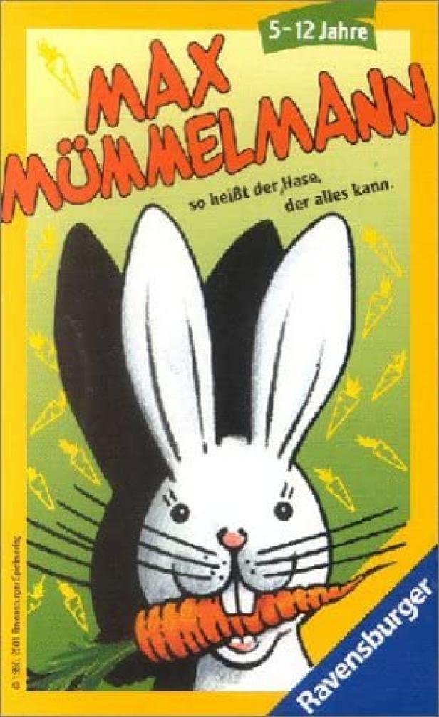Das Cover des Ravensburger-Spiels „Max Mümmelmann“ mit einem Hasen, der eine Karotte im Mund hält.