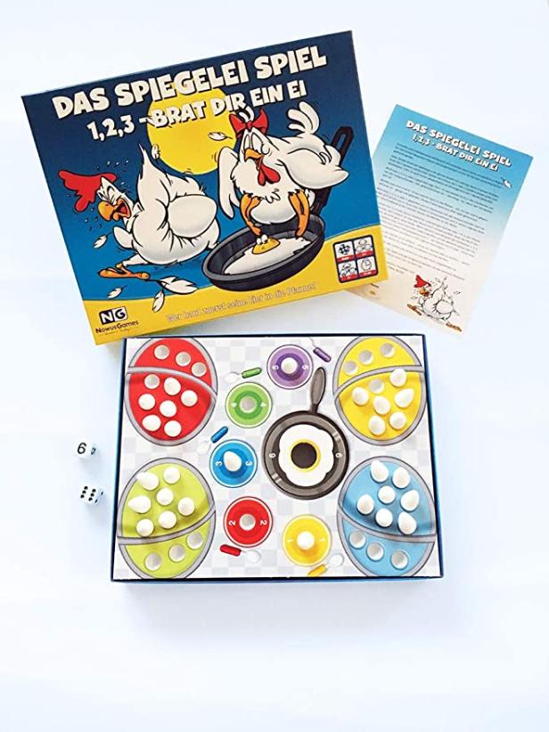 Das Brettspiel „Das Spiegelei Spiel 1,2,3-Brat dir ein Ei“ mit Spielbrett, Würfeln und Anleitung.