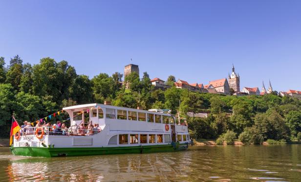 Ein Ausflugsschiff fährt auf dem Neckar vor der Stadt Horb am Neckar.