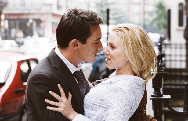 Scarlett Johansson und ein Mann in Anzug stehen einander nah.