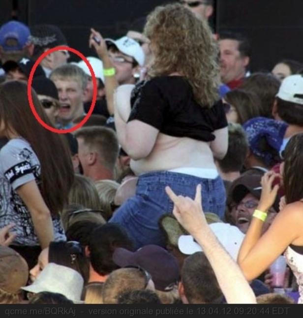 Eine Frau sitzt auf den Schultern einer Person bei einem Konzert.