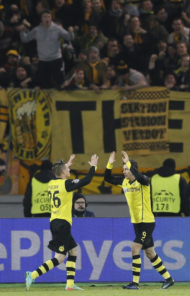 Die Fußballspieler Piszczek und Lewandowski feiern vor der gelben Wand der BVB-Fans.