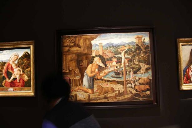 Ein Gemälde von Johannes dem Täufer in einer Landschaft mit Tieren.