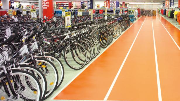 Viele Fahrräder stehen in einem Sportgeschäft zum Verkauf.