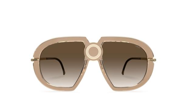 Eine beigefarbene Sonnenbrille mit braunen Gläsern und einem kreisförmigen Detail in der Mitte.