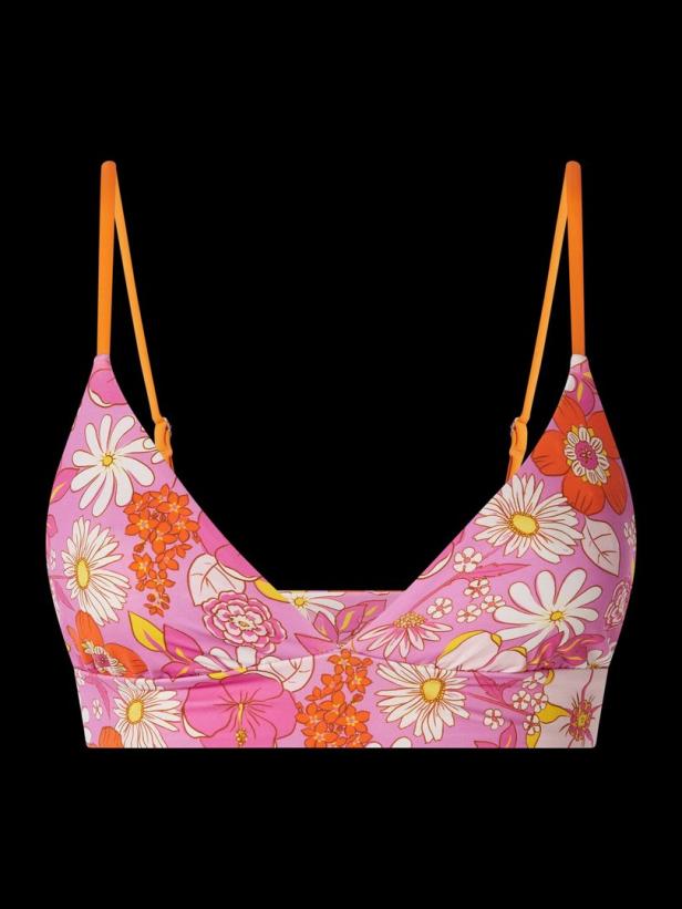 Ein rosafarbenes Bralette mit Blumenmuster und orangefarbenen Trägern vor schwarzem Hintergrund.