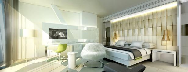 Ein helles, modern eingerichtetes Schlafzimmer mit einem großen Bett und einem Schreibtischbereich.