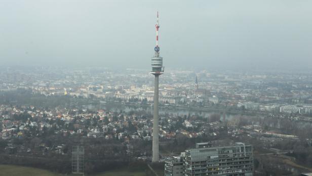 Der Donauturm überragt die Stadt Wien an einem trüben Tag.