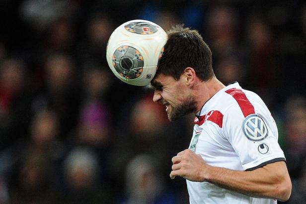 Ein Fußballspieler köpft einen Ball.