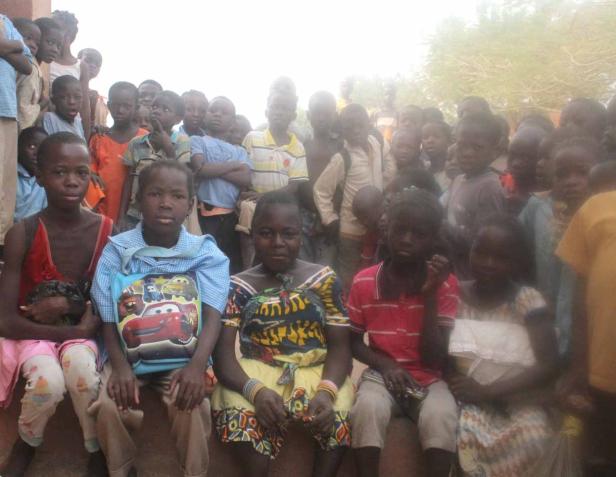 Eine Gruppe afrikanischer Kinder sitzt und steht zusammen.