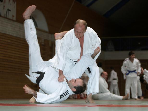 FILE PHOTO: Russia's Prime Minister Vladimir Putin attends a judo training session at Top Athletic School in St. Petersburg