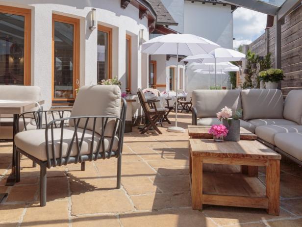 Einladende Terrasse mit bequemen Sitzmöbeln und Sonnenschirmen.