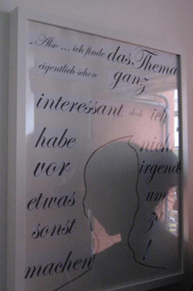 Ein gerahmtes Bild mit einem Zitat und einer stilisierten Silhouette eines Kopfes.