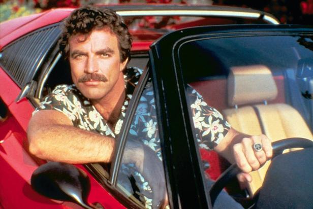 Tom Selleck als Thomas Magnum in einem roten Ferrari.
