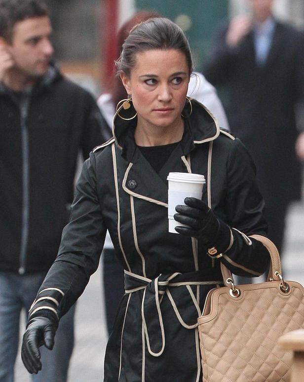Pippa Middleton mit einem Kaffee in der Hand auf einer Straße.