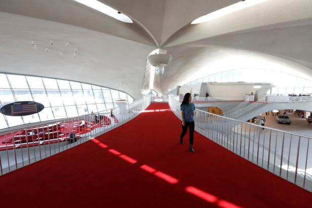 Eine Frau geht auf einem roten Teppich im TWA Hotel am John F. Kennedy Airport entlang.