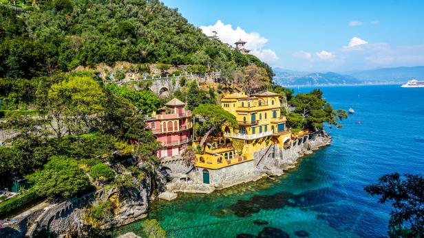 Bunte Häuser stehen auf einer Klippe am Meer in Portofino, Italien.
