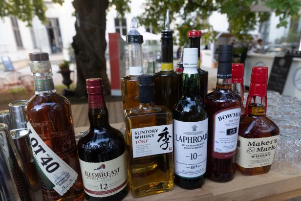 Eine Auswahl verschiedener Whisky- und Spirituosenflaschen auf einer Theke.