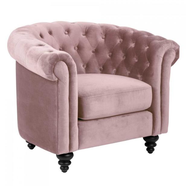 Ein rosa Sessel mit Knopfheftung und schwarzen Füßen.