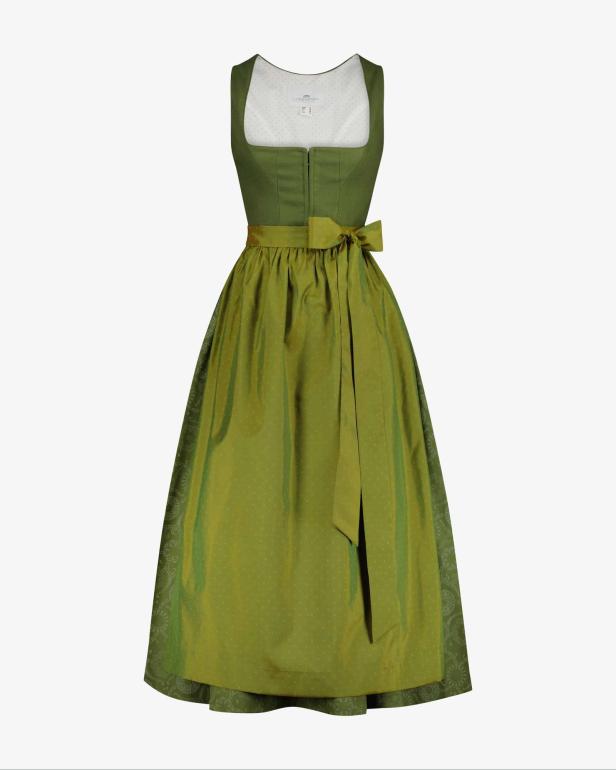 Ein grünes Dirndl mit Schleife vor einem weißen Hintergrund.