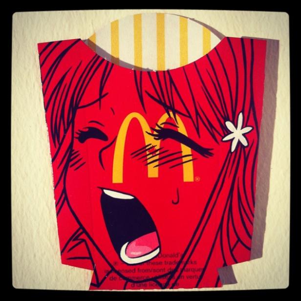 Eine stilisierte McDonald's-Pommes-Frites-Verpackung mit einem Manga-Gesicht darauf.