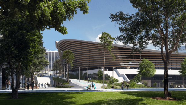 Das Aquatics Centre in Paris mit Menschen auf den Wegen und Grünflächen.